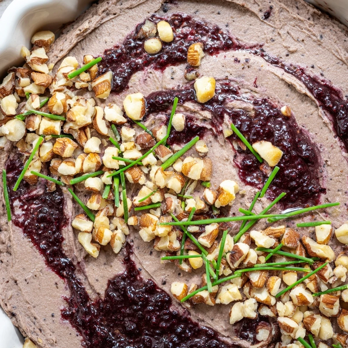 Elegant Velvet Underground appetizer: dark, smooth pâté paired with layered fruity jams and delicious, hidden nuts.