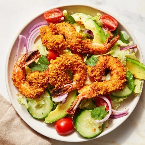 Spicy Crispy Shrimp Salad with golden fried shrimp, fresh avocado, and a vibrant dressing.