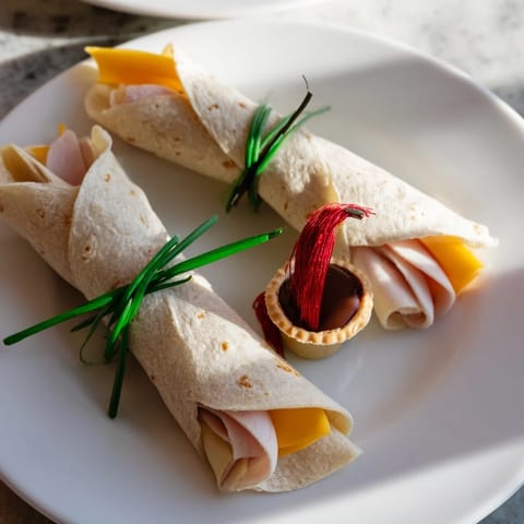 Close-up of freshly made Graduation Cap Diploma Snack Wraps, savory wraps and sweet cap treats, ready to eat.