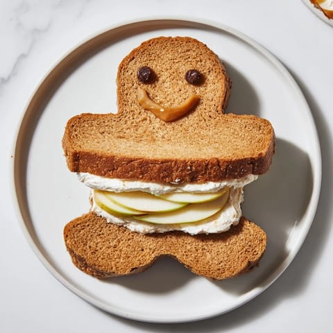 These fun Gingerbread Man Sandwich cutouts are a festive and delightful snack for kids' lunches.