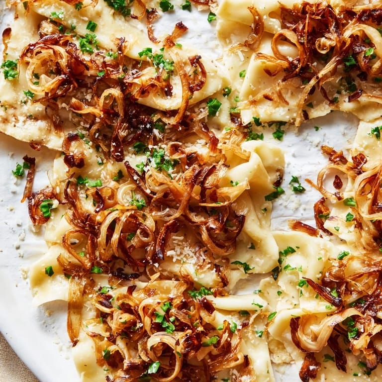 This baked German fusion, Savory Maultaschen Flatbread, has caramelized onions and fresh herbs for flavor.